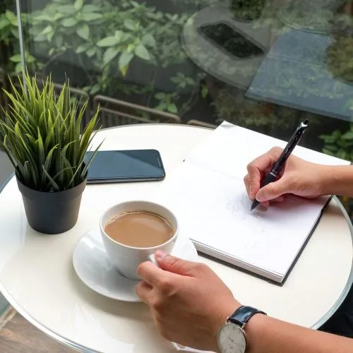mains notes café cahier plante verte Authenticité blog : ce qui sauve vos lecteurs de l'IA